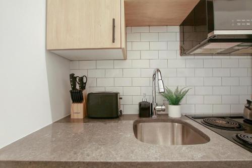 a kitchen with a sink and a counter top at Complete and Minimalist Studio Apt - Wilson 101 in Chicago
