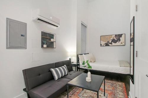 a living room with a couch and a bed at Complete and Minimalist Studio Apt - Wilson 101 in Chicago