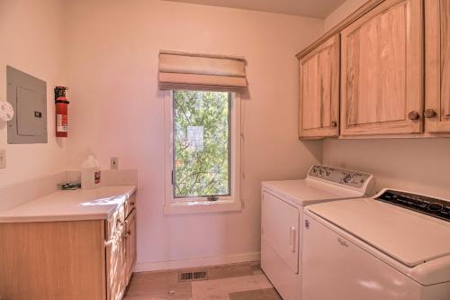 a kitchen with a washer and dryer and a window at Oceanfront Point Arena House with Lovely Deck! in Point Arena