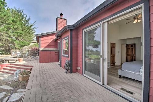 a red house with a large sliding glass door at Oceanfront Point Arena House with Lovely Deck! in Point Arena