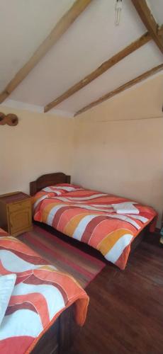a bedroom with two beds in a room at Inka Wasi in Isla de Sol