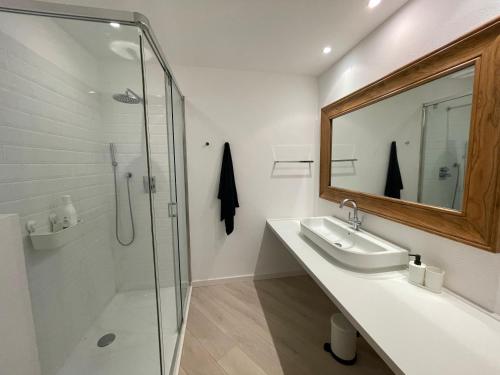 a bathroom with a shower and a sink and a mirror at Cap Sa Sal - Sa Roca 3 in Begur