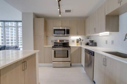 a kitchen with a stove and a microwave at Fantastic 2BR Condo At Crystal Flats With Rooftop 915 in Arlington