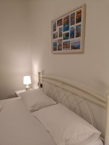 a bedroom with two beds and a picture on the wall at SUNNY HOLIDAYS APARTMENT in Kremasti