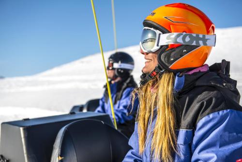 a person wearing a helmet and goggles on a ski lift at Hotell Fjället in Björkliden