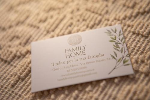 a small card sitting on top of a piece of cloth at Family Home in Quartu SantʼElena