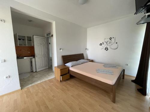 Кровать или кровати в номере Apartmani Vila Milaris