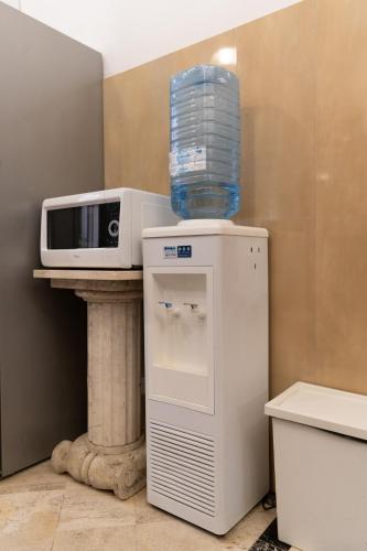 a microwave sitting on top of a refrigerator at Korean Sonata in Rome