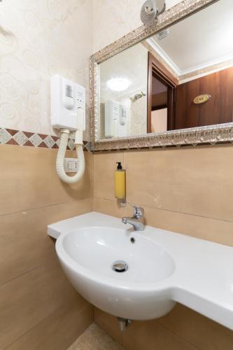 a bathroom with a white sink and a mirror at Korean Sonata in Rome