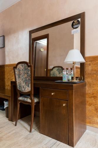 a desk with a chair and a mirror at Korean Sonata in Rome