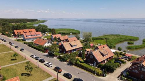 an aerial view of a town with a river and houses at Marių vėjas in Nida