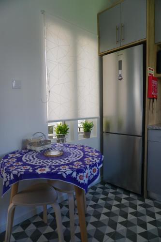 a kitchen with a table with a purple table cloth at Portela House - T3 Residential home 50 meters from the beach in Vila Praia de Âncora