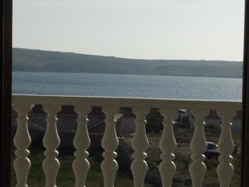 einen Balkon mit Blick auf das Wasser in der Unterkunft Apartments Kuss in Novalja