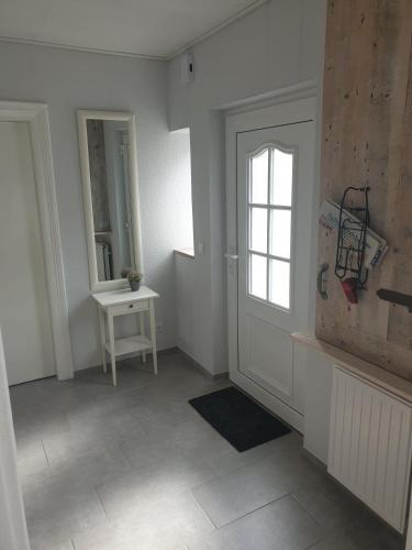 a room with a door and a table and a window at Auszeit! in Büdelsdorf