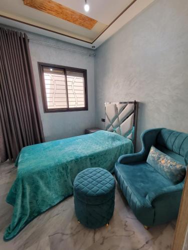 a bedroom with a bed and a couch and a chair at ZR Comfort Delux in Fez