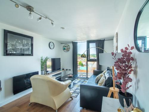 a living room with a blue couch and a chair at Exquisite 2-bedroom Apartment - City Centre in Sheffield