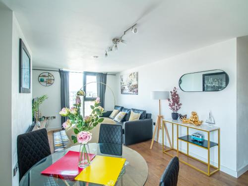 a living room with a couch and a table at Exquisite 2-bedroom Apartment - City Centre in Sheffield