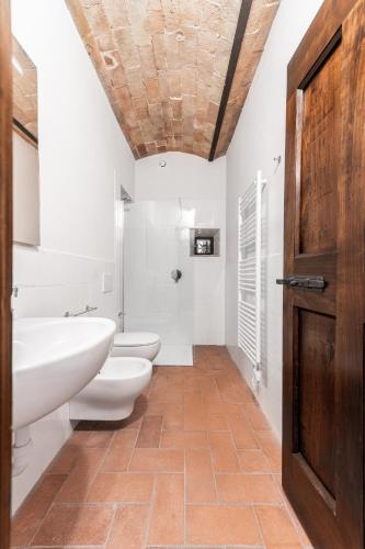 a bathroom with two toilets and a sink at Podere Mezzastrada - Place of Charme in Fiano