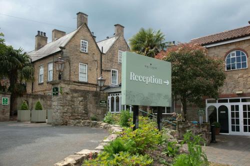 a sign in front of a large building at Hall Garth Hotel Darlington, Sure Hotel Collection by BW in Darlington