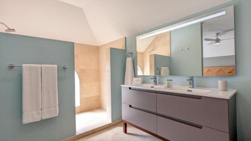 uma casa de banho com um lavatório e um espelho em St George's Club em Saint George