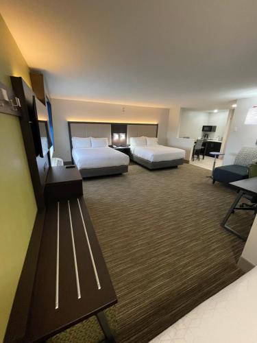 a hotel room with two beds and a desk at Holiday Inn Express Hotel & Suites Las Vegas by IHG in Las Vegas