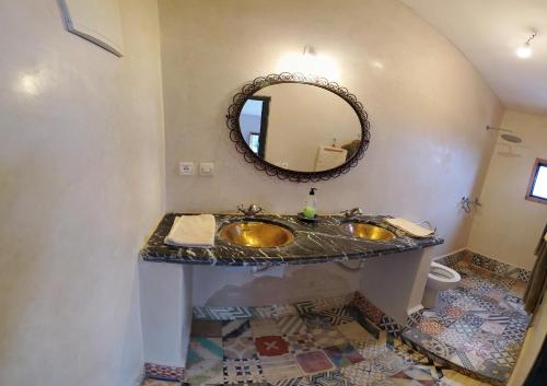 a bathroom with a sink and a mirror at ourika oufla in Ourika