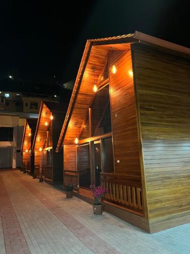 a row of wooden buildings with lights on them at Mi Margarita Chalets in Alausí