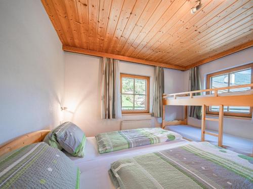 two beds in a room with a bunk bed at Landhaus Hotter 18 in Neukirchen am Großvenediger