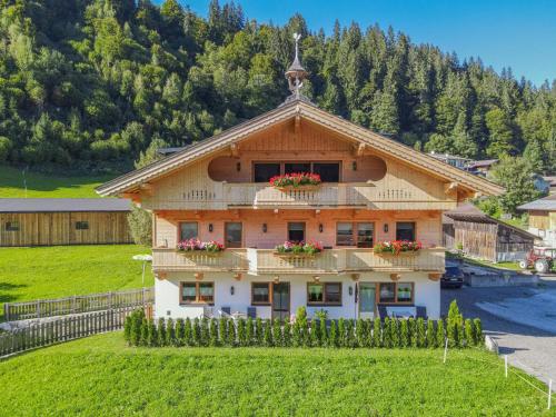 a building with flower boxes on the top of it at Festenhof in Hopfgarten im Brixental