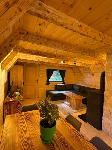 a living room with a couch and a table at Rajska suma in Žabljak