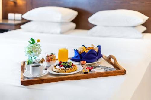 a tray of breakfast food on a bed at Hyatt Regency Villahermosa in Villahermosa