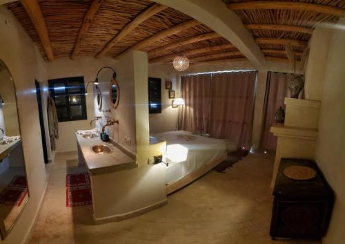 a bedroom with a bed and a sink and a mirror at ourika oufla in Ourika
