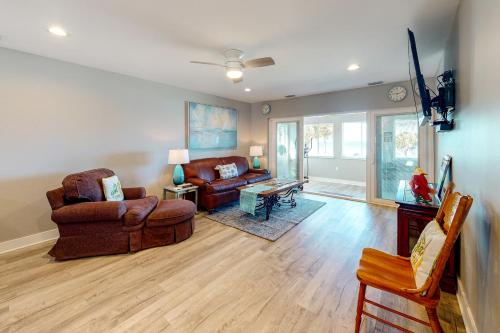 a living room with two chairs and a couch at Isle of View Too in Mexico Beach