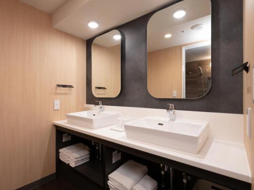 a bathroom with two sinks and a mirror at MIMARU Tokyo Kinshicho in Tokyo
