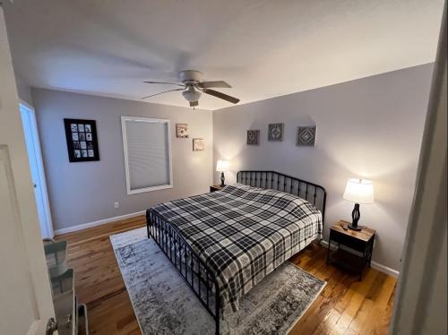 a bedroom with a bed and a ceiling fan at Kid-Friendly Townhouse Near Lake & Sports Complex in Guntersville