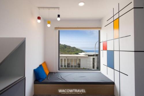 a room with a window with a bed in it at Twenty Eight B&B in Xiaoliuqiu