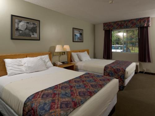 a hotel room with two beds and a window at Sierra Sands Family Lodge in Mears