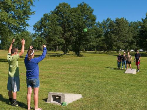 a group of people standing in a field with their hands up at Sierra Sands Family Lodge in Mears
