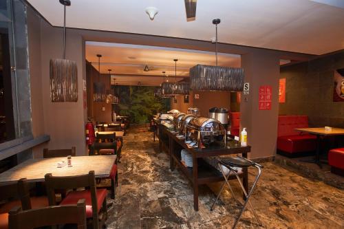 a restaurant with tables and chairs in a room at Casa Andina Standard Machu Picchu in Machu Picchu