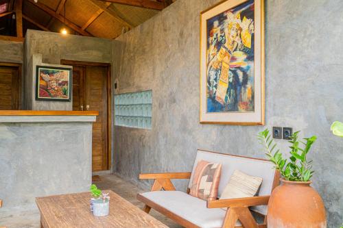 a patio with a bench and a table and a painting at Cloud Hills Glamping by Bukit Vista in Kintamani