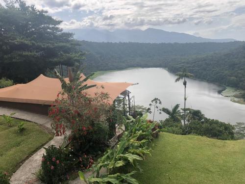 a view of a body of water with a building at Casa maar -Tented Camp in Río Cuarto