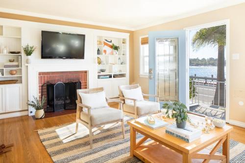 a living room with a fireplace and a tv at Kokomo by AvantStay Bayside Getaway w Fire Pit Large Outdoor Patio in San Diego