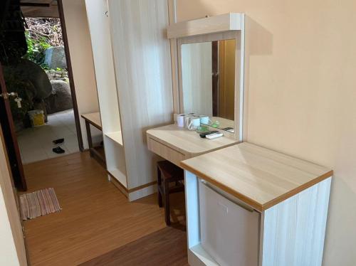 a bathroom with a sink and a mirror at Cozy Resort in Perhentian Island