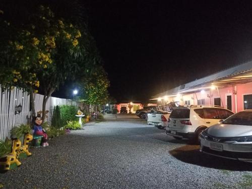 a parking lot at night with cars parked at Saan Rak Resort in Prachuap Khiri Khan