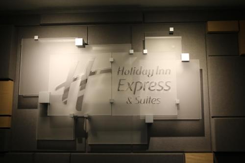 a sign that says holiday inn express and suites on a wall at Holiday Inn Express, an IHG Hotel in Douglas