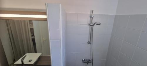 a shower stall in a bathroom with a sink at Studio annabella vue mer manganao in Saint-François