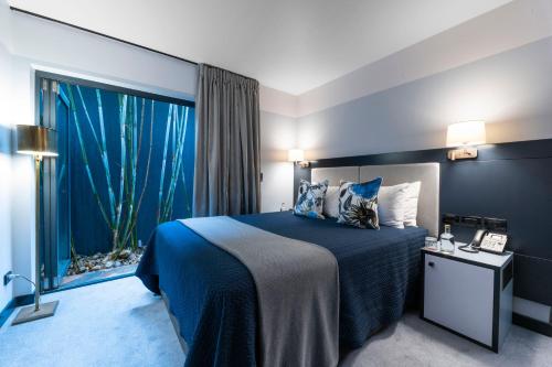 a bedroom with a bed and a large window at Spicers Balfour Hotel in Brisbane