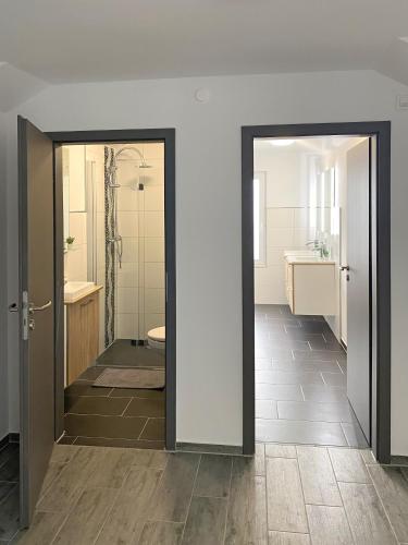 a bathroom with a shower and a toilet and a sink at Dock 6 - Cuxhaven in Cuxhaven