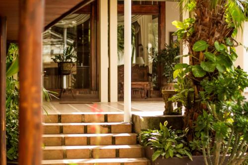 a house with stairs leading to the front porch at La Riviera Hotel in San Antonio