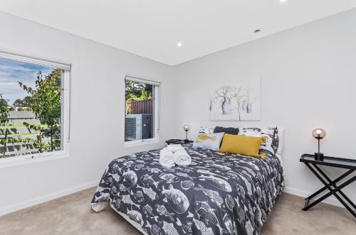 a bedroom with a large bed and a window at Absolute in Port Fairy